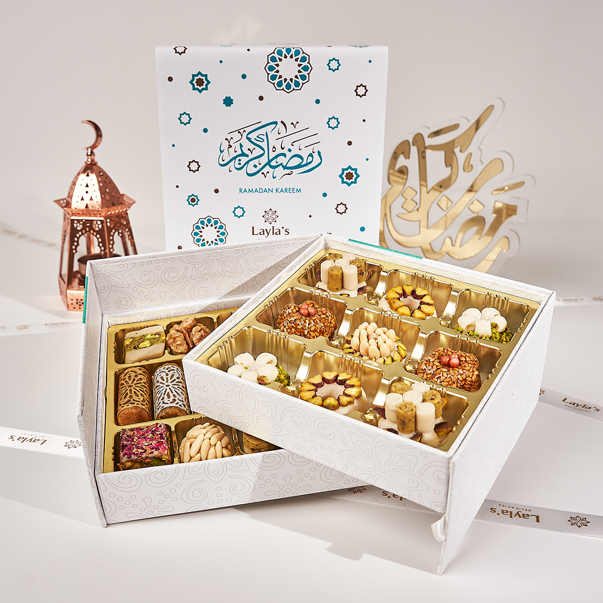 An open white gift box full of Ramadan sweets